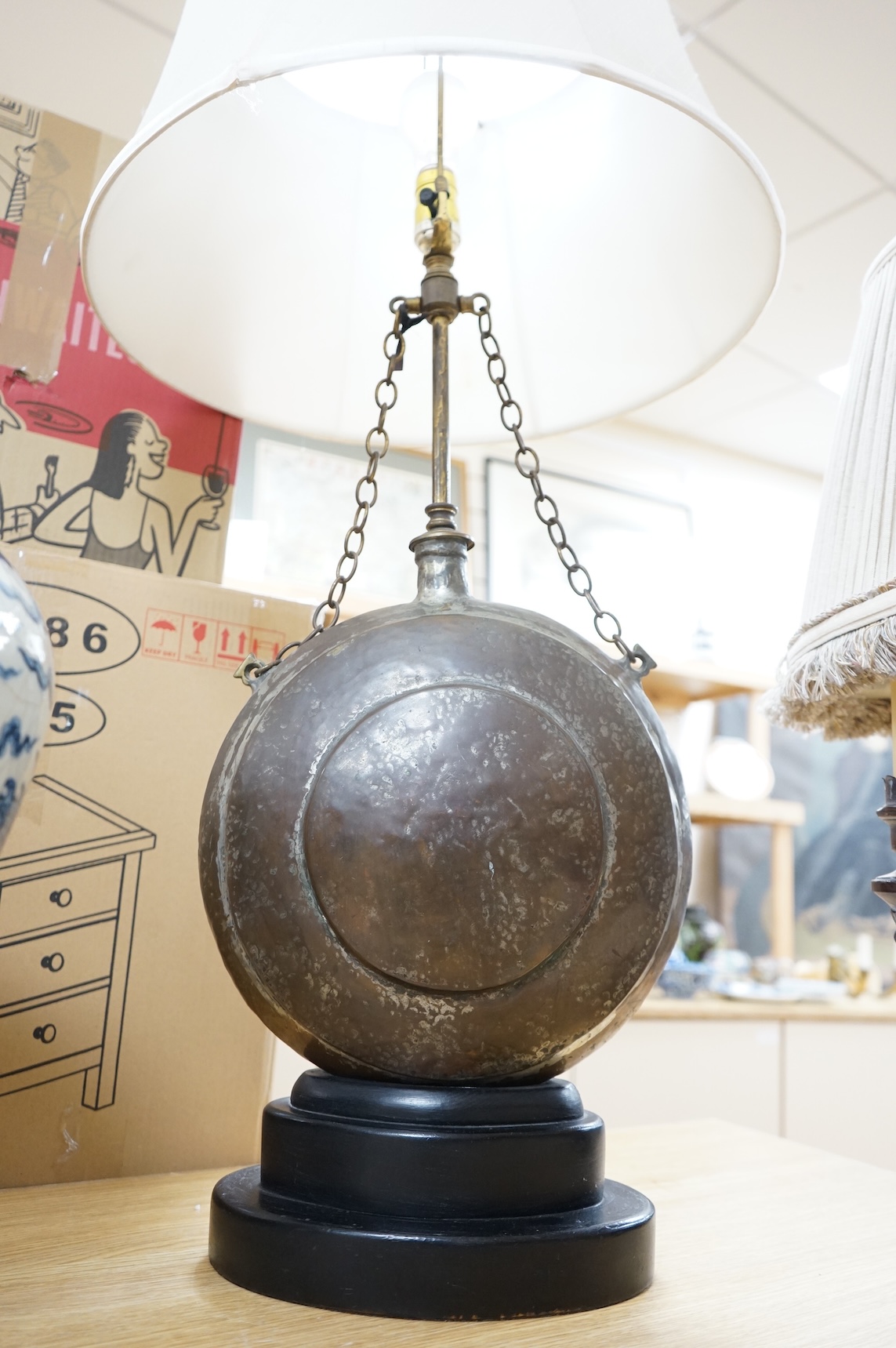 A Frederick Cooper Bouillotte lamp, together with a hammered metal table lamp, formed from a water flask (2)